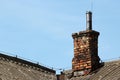 Old brick smoke stack on a slate roof Royalty Free Stock Photo