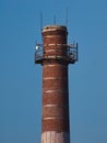 Old brick smokestack on sky blue background Royalty Free Stock Photo