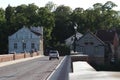 Old brick and stone bridge over small river near old city with ancient houses,  city Goldingen - Latvia, Europe. Royalty Free Stock Photo