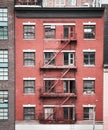 Old brick tenement house with fire escape, color toned picture, New York City, USA