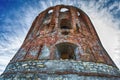 old brick tower under a blue cloudy sky Royalty Free Stock Photo