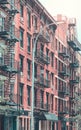 Old brick townhouses with fire escapes, color toning applied, New York City, USA Royalty Free Stock Photo