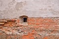 Old brick wall from an ancient fortress with small window Royalty Free Stock Photo