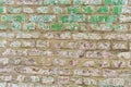 An old brick wall with a background of white and red bricks and old faded green paint Royalty Free Stock Photo