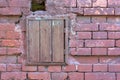 Old brick wall with a closed wooden window. Royalty Free Stock Photo