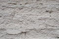 Old brick wall covered with white paint rough chipped texture background Royalty Free Stock Photo