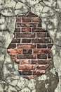 Old brick wall with crumbling plaster cracked