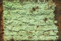 Old brick wall with dirty peeling paint. Close-up texture, vintage background Royalty Free Stock Photo