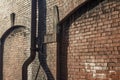 Old brick wall exterior of an old warehouse, pipes, perspective view