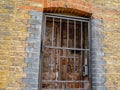 Old brick wall with iron security grille and lock Royalty Free Stock Photo