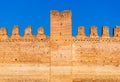 Old brick wall of medieval Italian fortress against the blue sky Royalty Free Stock Photo