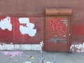 Old brick Wall with metallic roller shutter door. Abandoned industrial area