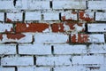 Old brick wall with old white paint. Painted distressed wall surface. Vintage Red Brick Wall With Sprinkled Plaster Royalty Free Stock Photo