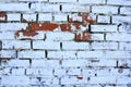 Old brick wall with old white paint. Painted distressed wall surface. Vintage Red Brick Wall With Sprinkled Plaster Texture Royalty Free Stock Photo