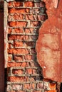 Old brick wall with peeling plaster, grunge background. Royalty Free Stock Photo