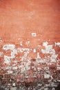 Old brick wall with peeling plaster, grunge background. Royalty Free Stock Photo