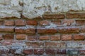 Old brick wall with pieces of plaster. Grunge background with red bricks and cement layers. Royalty Free Stock Photo