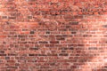 Old brick wall of red color, damaged masonry as abstract background composition