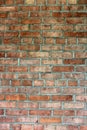 Old weathered brick wall with red and brown bricks throughout Royalty Free Stock Photo