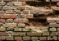 Old brick wall with unevenly sized red and brown bricks. Visible Royalty Free Stock Photo