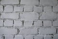 Old brick wall with white paint background texture close up.Background of old vintage dirty brick wall with peeling plaster.White Royalty Free Stock Photo