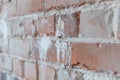 Old brick wall with white paint background texture close up. Side view, low depth of field. Royalty Free Stock Photo