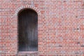 Old brick wall with wooden door. Royalty Free Stock Photo