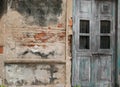 Old brick wall and wooden green door shabby