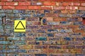 Old brick wall with yellow sign Royalty Free Stock Photo