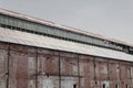 Old brick warehouse building with corrugated metal roof Royalty Free Stock Photo