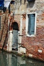 Venice, Castello. Reflection.Old brickhouse. Blue shutters.