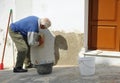 Old bricklayer working on the arrangement of your home