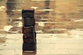 Old bricks used in construction stacked over one another on wet floor of the terrace after rainfall Royalty Free Stock Photo