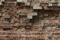 Old brickwork. A fragment of a collapsing wall. Textured background image