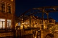 An old bridge The Kerkbrug on the Oude Rijn river, lit by beautiful lamp-posts, Leiden, the Netherlands Royalty Free Stock Photo