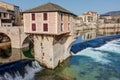 The old bridge and the old mill at the edge of the Tarn river in Millau - Aveyron - France Royalty Free Stock Photo