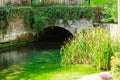 Old bridge over river Coln in village Bibury England Royalty Free Stock Photo