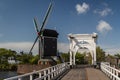 Old bridge and windmill Royalty Free Stock Photo