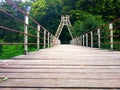 Old bridge with a wooden walkway in perspective. Royalty Free Stock Photo