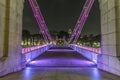 Old brightly illuminated bridge on the Singapore river at night