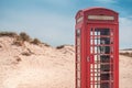 An old British red telephone box in the sand dunes of a deserted beach at Studland, near Sandbanks, Dorset, England, UK Royalty Free Stock Photo