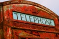 Old British telephone box with peeling paint Royalty Free Stock Photo