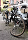 Old broken bicycle with a crooked wheel