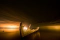 Old broken boat wreck on the shore, a frozen sea and beautiful blue sunset background. Royalty Free Stock Photo