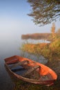 Old broken boat near lake .Foggy morning in autumn Royalty Free Stock Photo