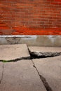 Old Broken Cement Cracked Sidewalk Brick Wall Royalty Free Stock Photo