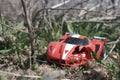old broken children's toy sports car lies in the grass