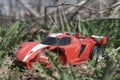 old broken children's toy sports car lies in the grass