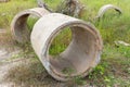 Old broken concrete cement pipe in grass, Royalty Free Stock Photo