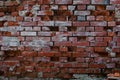 Old broken, damaged and corroded brick wall with broken bricks missing and leaving holes in the wall for background or wallpaper Royalty Free Stock Photo